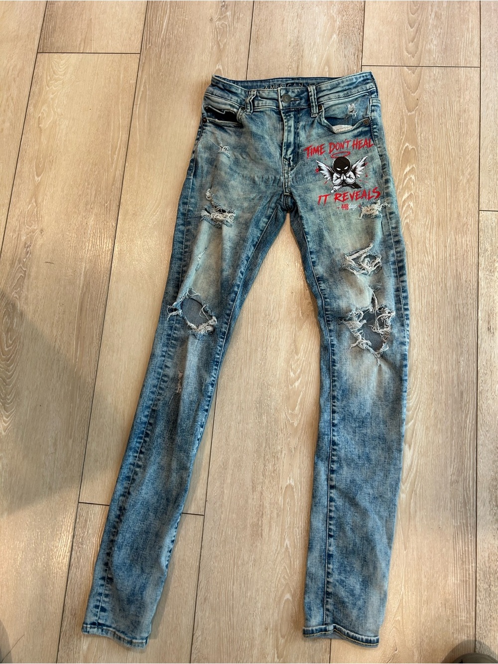 American Eagle Outfitters Distressed Light Blue Skinny Jeans with Red Graphic